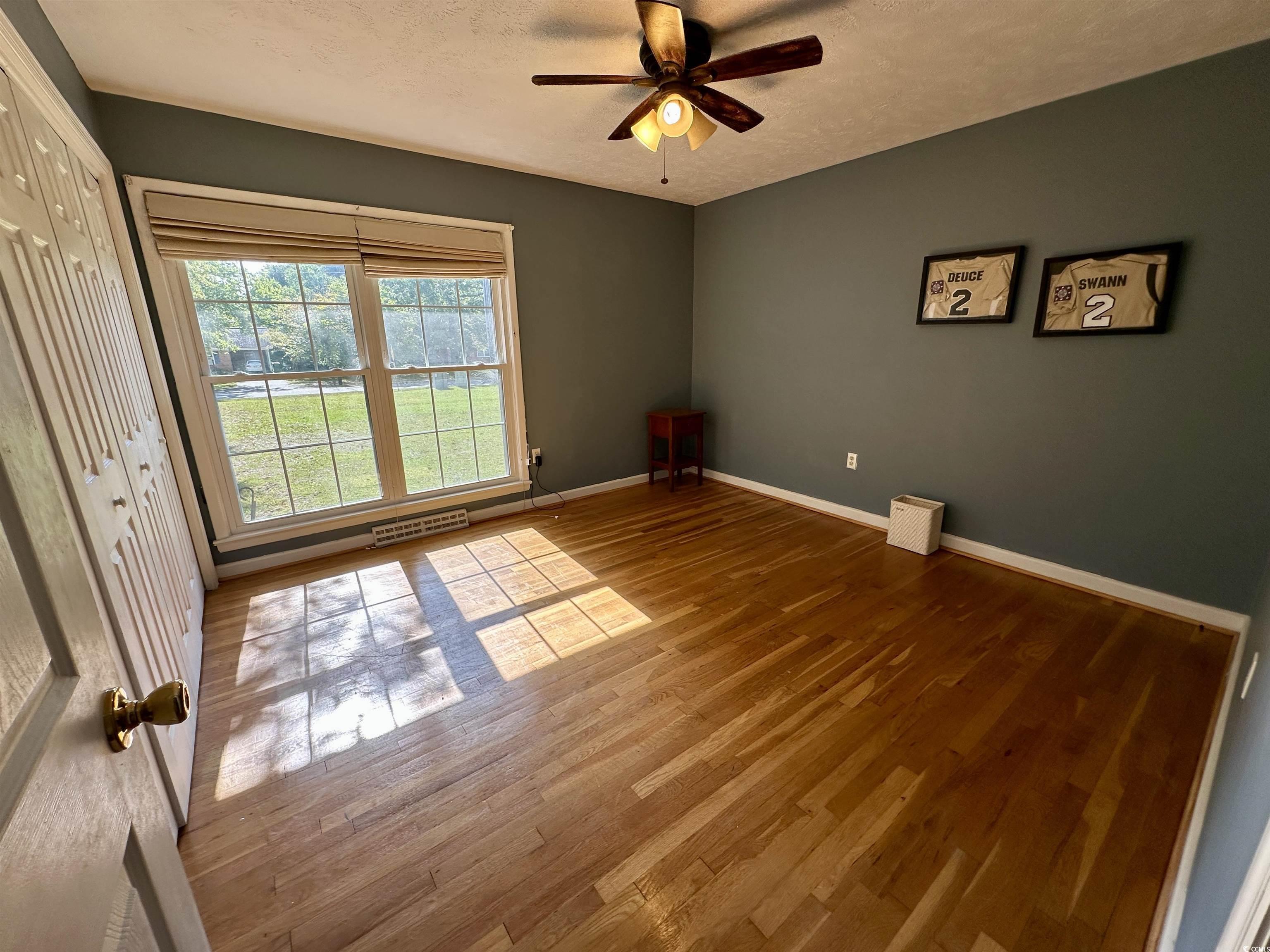 601 Jefferson Street Bennettsville, SC 29512 - Photo 15 of 20 Unfurnished room with wood finished floors, a textured ceiling, and a ceiling fan