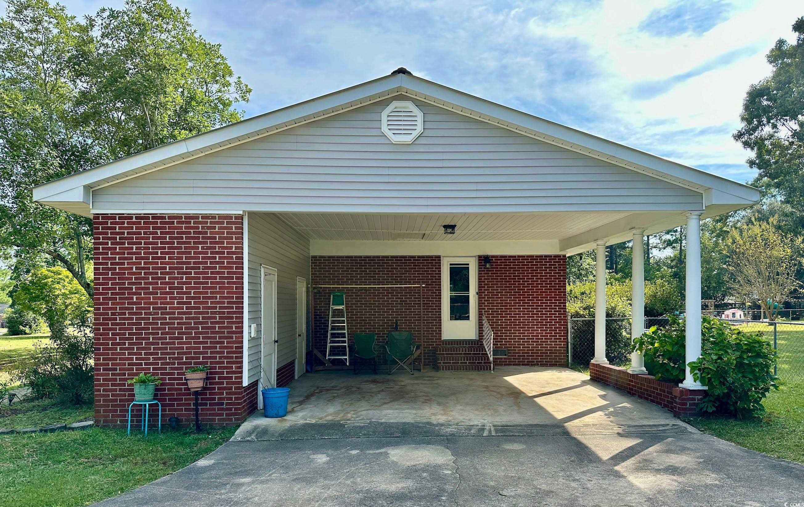 601 Jefferson Street Bennettsville, SC 29512 - Photo 2 of 20 Ranch-style house with brick siding, driveway, and an attached carport