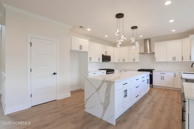 a large white kitchen with a large window