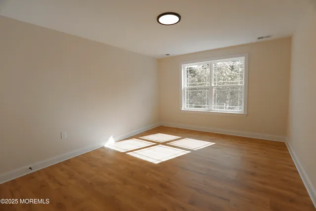 a view of a white house with a big yard and large trees