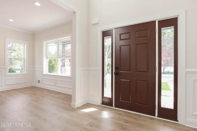 a kitchen with kitchen island granite countertop a sink cabinets and wooden floor