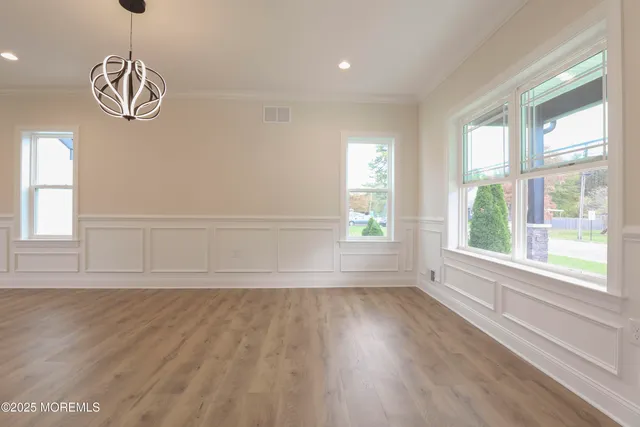 a kitchen with kitchen island a sink a stove a refrigerator and white cabinets