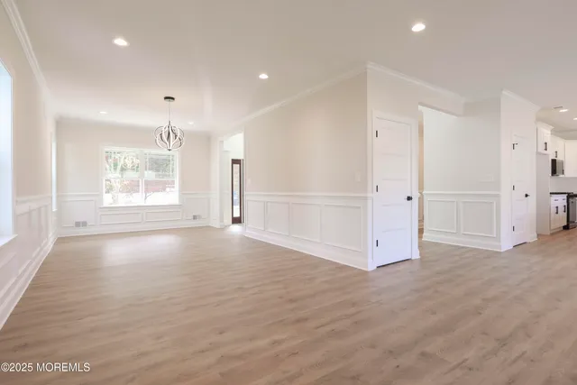 a large white kitchen with white cabinets