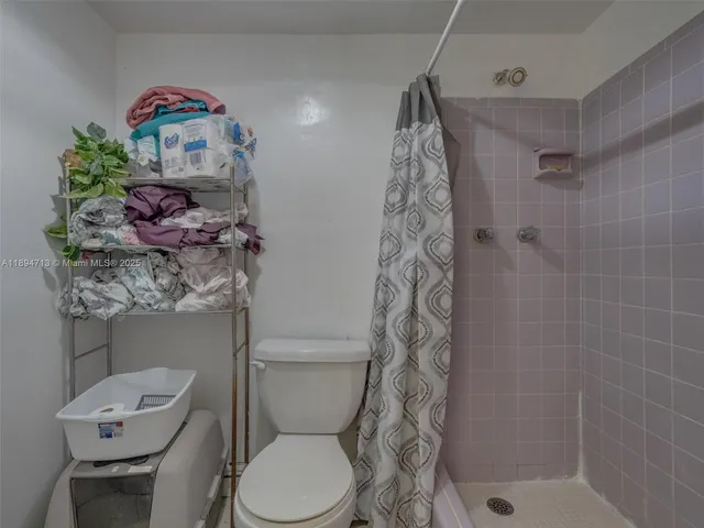a bathroom with a toilet sink and shower