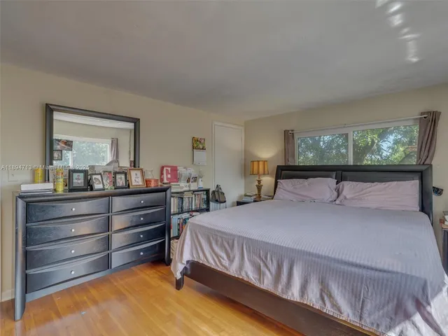 a bedroom with a bed and a flat tv screen