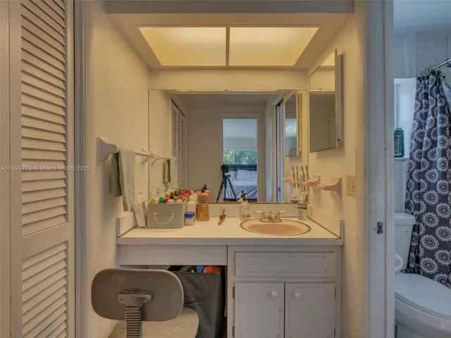 a bathroom with a shower curtain and a toilet