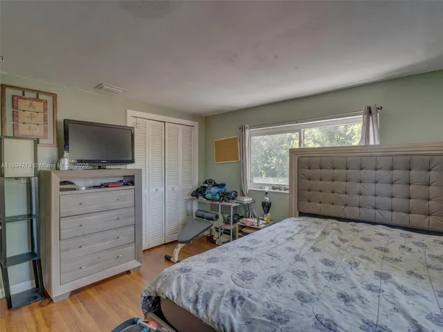 a bedroom with two beds and a large window