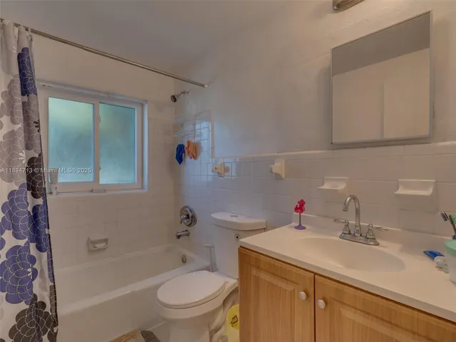 a bathroom with a toilet a sink and bathtub