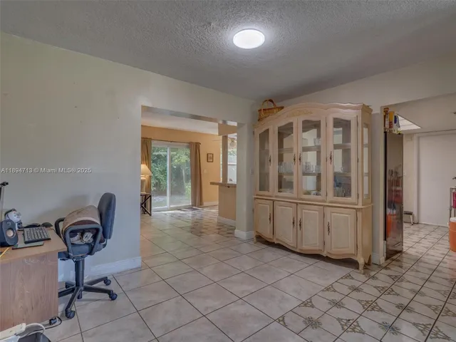 a view of a dining room with furniture and a chandelier fan