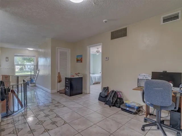a kitchen with a refrigerator and cabinets