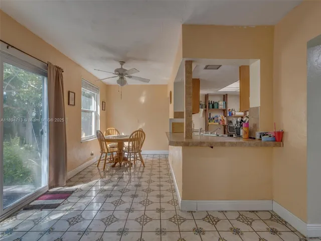 a backyard of a house with table and chairs