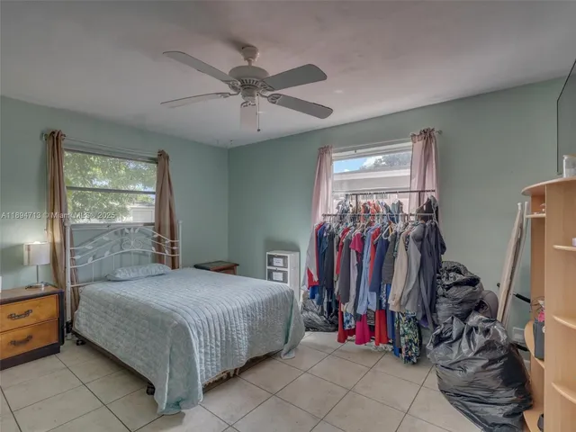 a bed room with a bed and a large mirror
