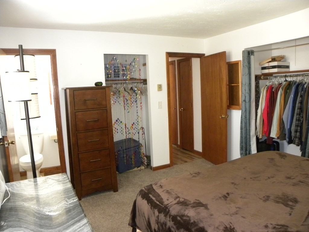 51 J Davis Road Charlton, MA 01507 - Photo 11 of 30 a bedroom with a bed closet and a large mirror