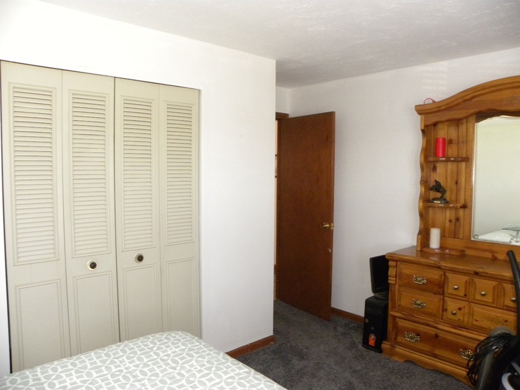 51 J Davis Road Charlton, MA 01507 - Photo 14 of 30 a bedroom with a bed and a dresser