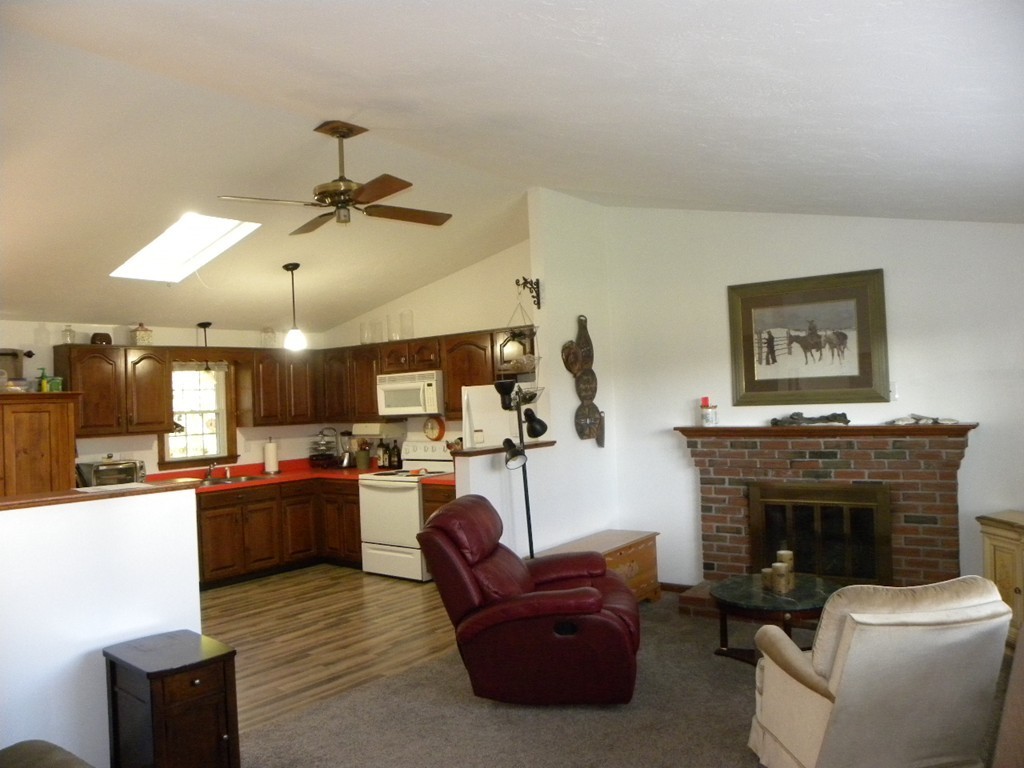 51 J Davis Road Charlton, MA 01507 - Photo 3 of 30 a living room with furniture a fireplace and kitchen view
