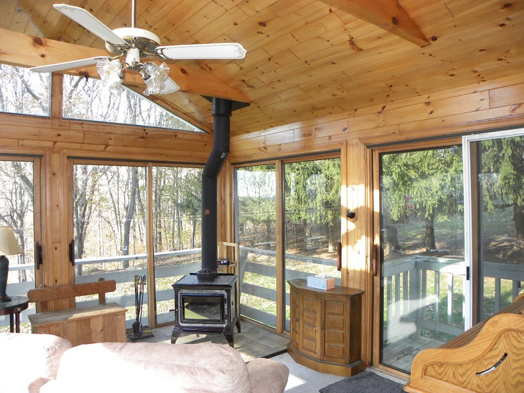 51 J Davis Road Charlton, MA 01507 - Photo 4 of 30 a dining room with wooden floor glass table and chairs