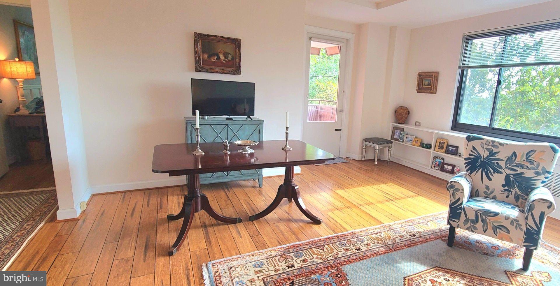 1021 Arlington Boulevard, Unit 330 Arlington, VA 22209 - Photo 13 of 48 a view of a room with furniture window and wooden floor