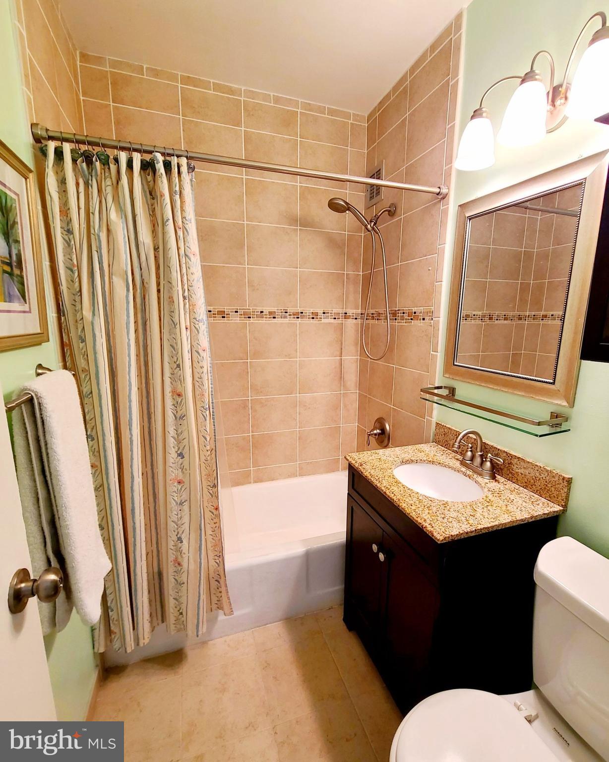 1021 Arlington Boulevard, Unit 330 Arlington, VA 22209 - Photo 22 of 48 a bathroom with a double vanity sink toilet and shower