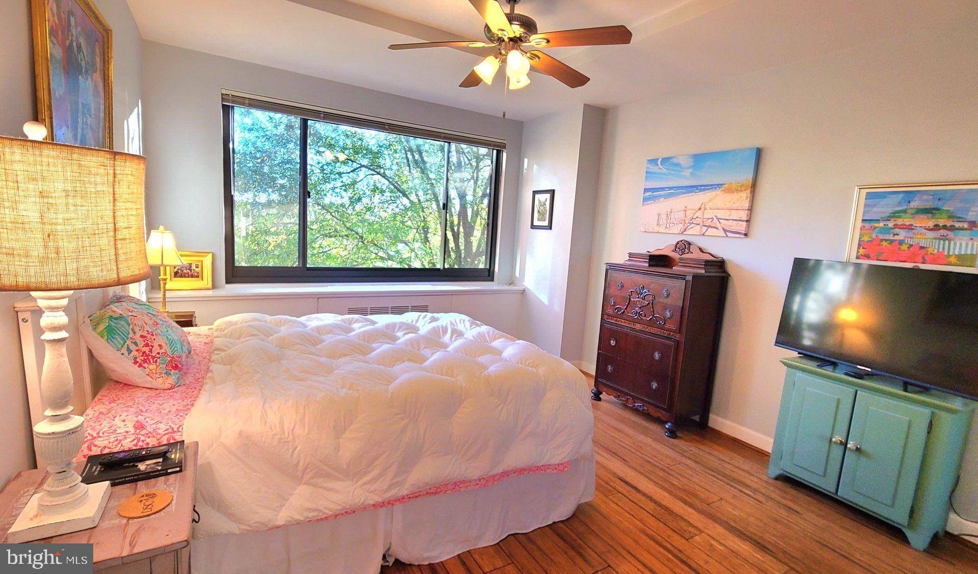 1021 Arlington Boulevard, Unit 330 Arlington, VA 22209 - Photo 23 of 48 a bedroom with a bed and a flat screen tv