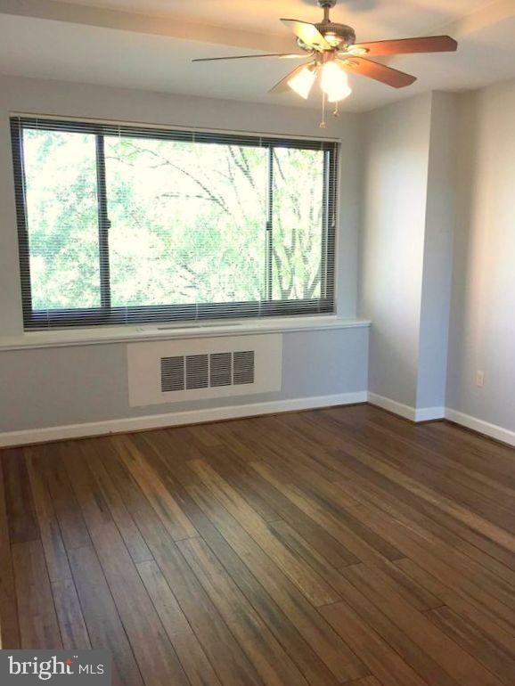 1021 Arlington Boulevard, Unit 330 Arlington, VA 22209 - Photo 25 of 48 a view of an empty room with wooden floor and a window