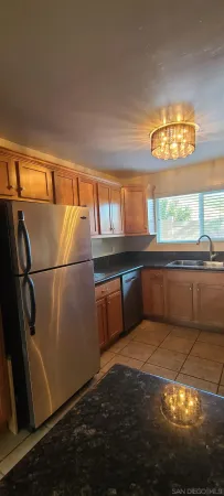 a view of a kitchen with large windows