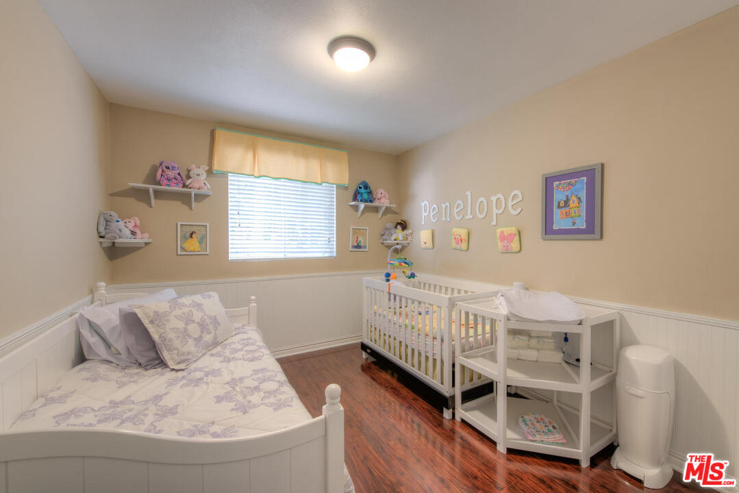 10541 Chandler Boulevard North Hollywood, CA 91601 - Photo 11 of 17 a bedroom with furniture and a large window