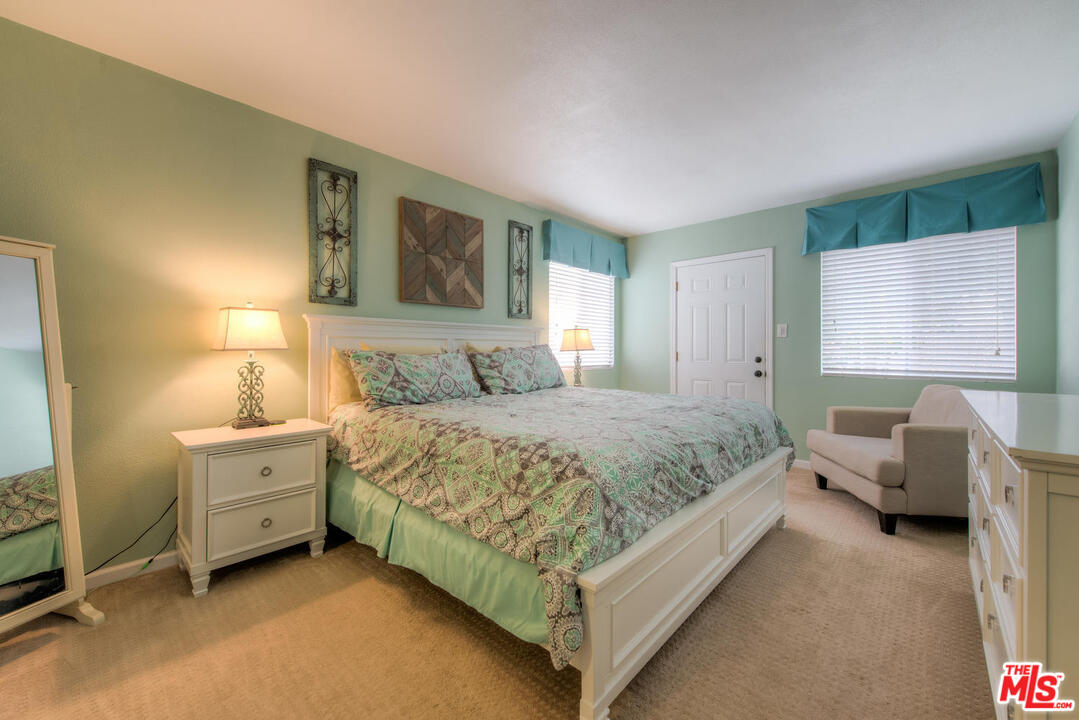 10541 Chandler Boulevard North Hollywood, CA 91601 - Photo 12 of 17 a spacious bedroom with a bed and a couch