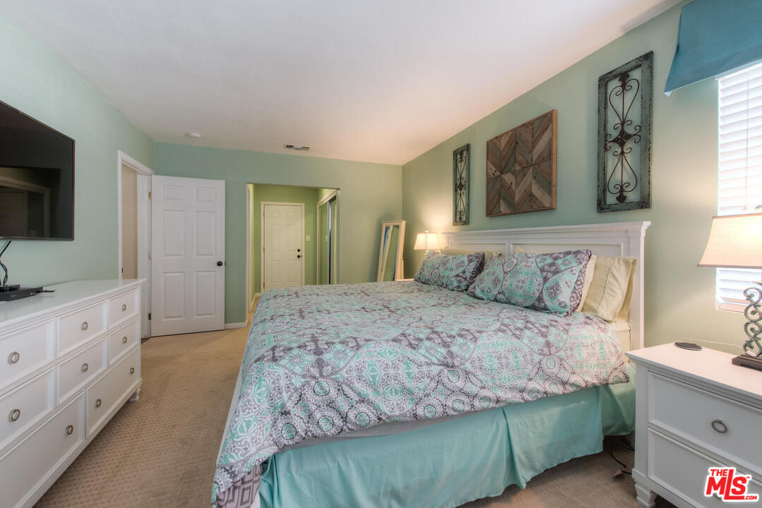 10541 Chandler Boulevard North Hollywood, CA 91601 - Photo 14 of 17 a bedroom with a bed and a flat screen television