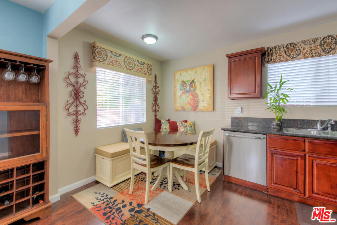 10541 Chandler Boulevard North Hollywood, CA 91601 - Photo 5 of 17 a dining room with a sink a counter and chairs