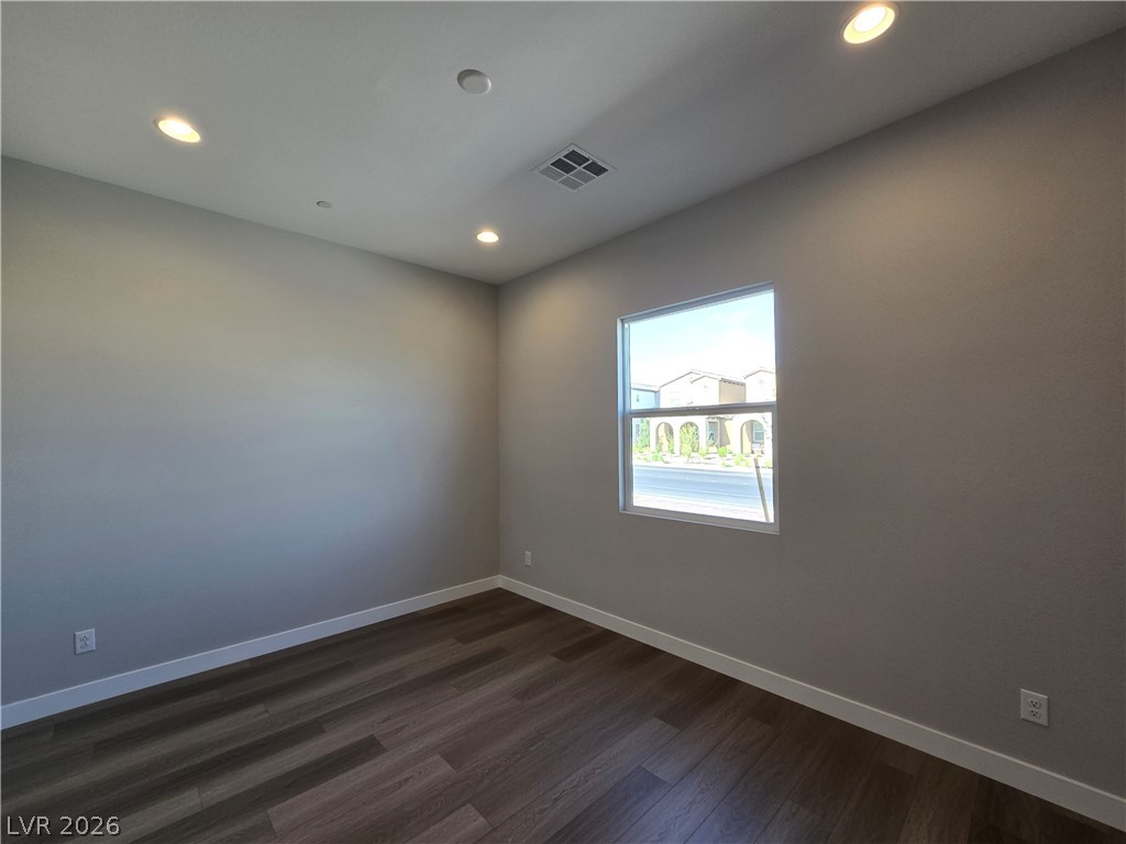 852 Weston Ridge Street Henderson, NV 89011 - Photo 23 of 28 A quiet space with rich hardwood flooring and recessed lighting offers an inviting ambiance.