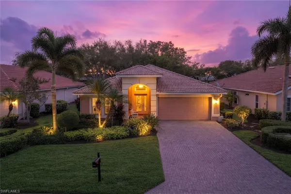 a front view of a house with a yard and a yard