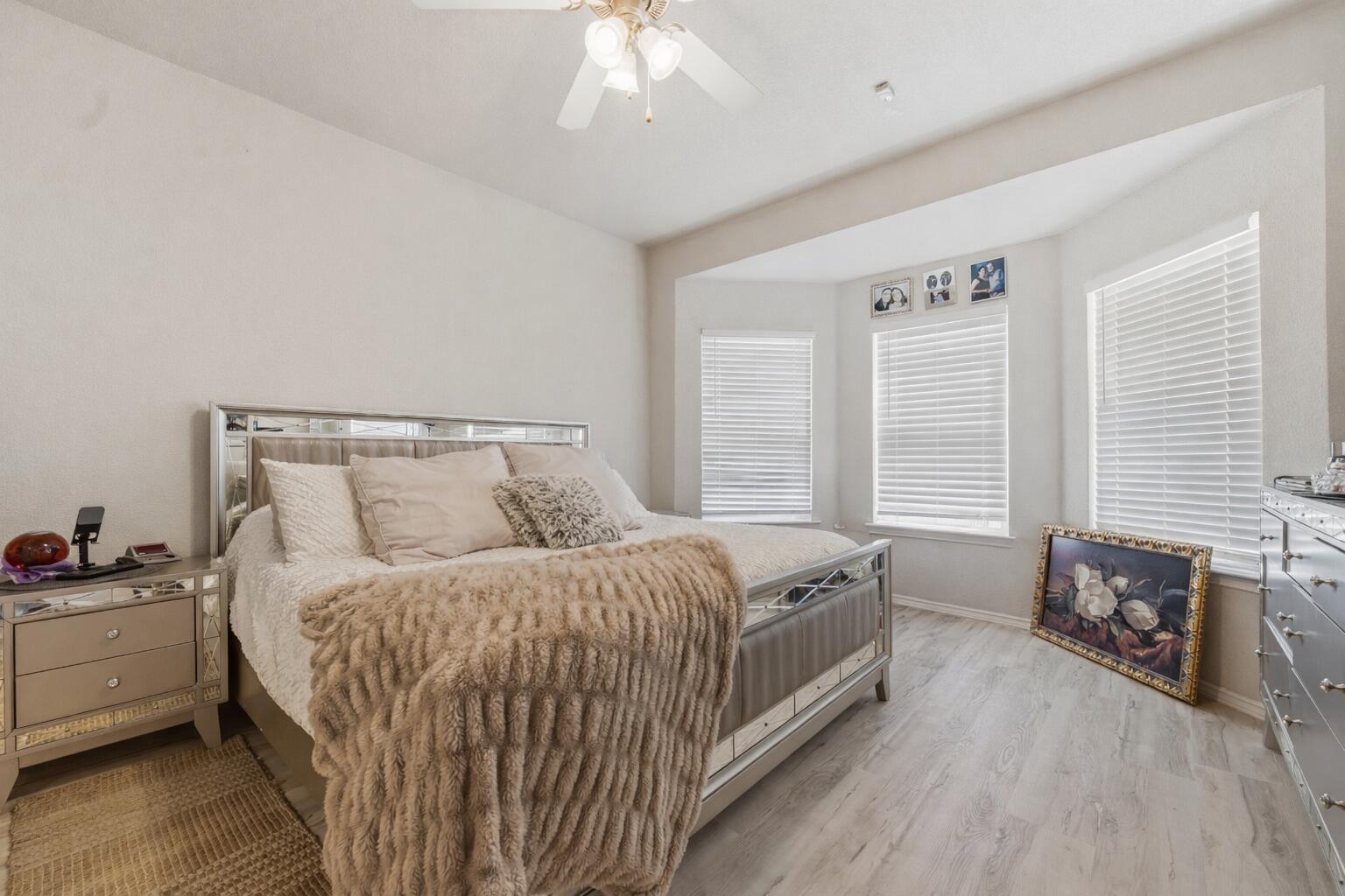 5833 102nd Street Lubbock, TX 79424 - Photo 16 of 36 a bedroom with a bed and a chandelier
