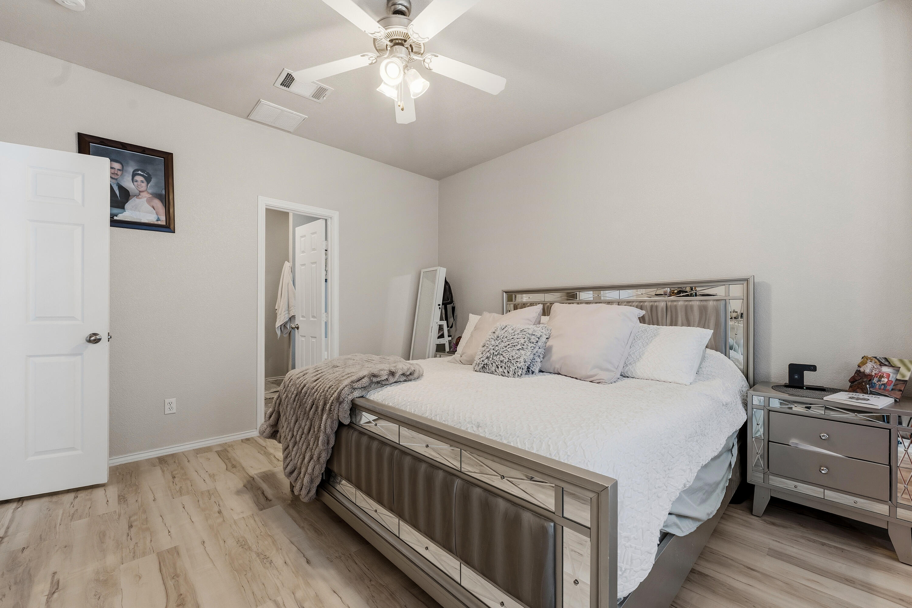 5833 102nd Street Lubbock, TX 79424 - Photo 17 of 36 a bedroom with a bed and a chandelier