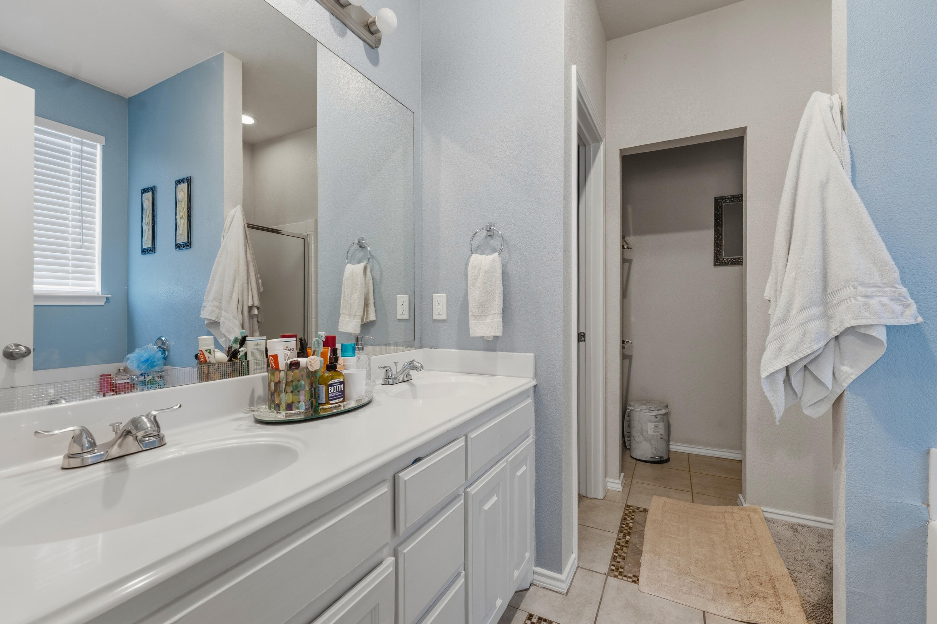 5833 102nd Street Lubbock, TX 79424 - Photo 18 of 36 a bathroom with a sink and a mirror