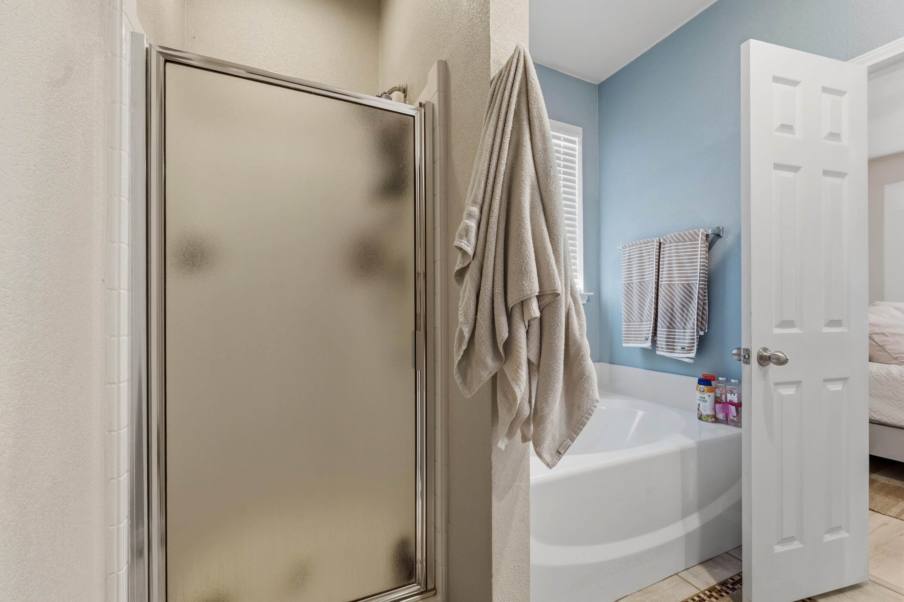 5833 102nd Street Lubbock, TX 79424 - Photo 19 of 36 a bathroom with a tub and a shower