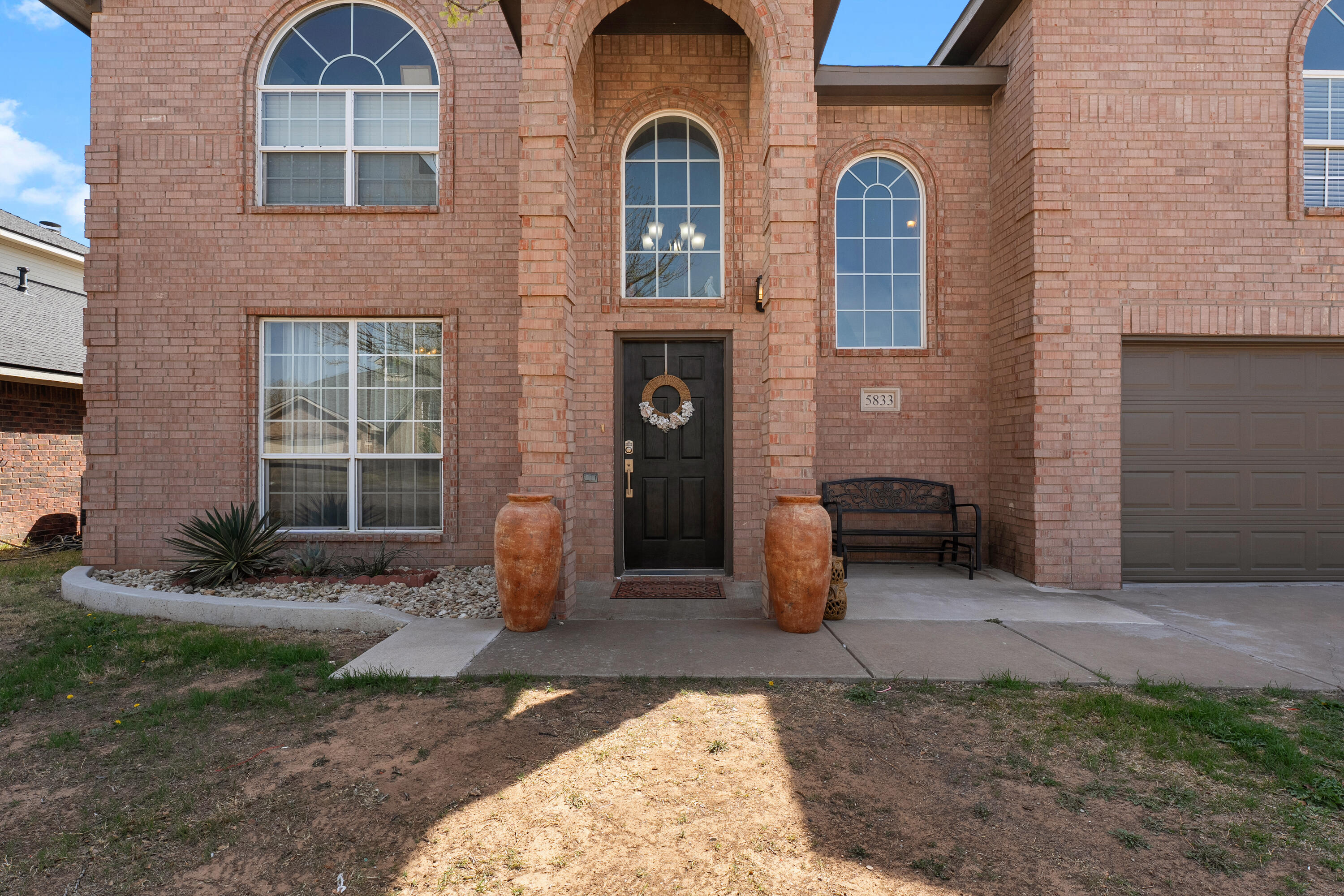 5833 102nd Street Lubbock, TX 79424 - Photo 2 of 36 a front view of a house with garden