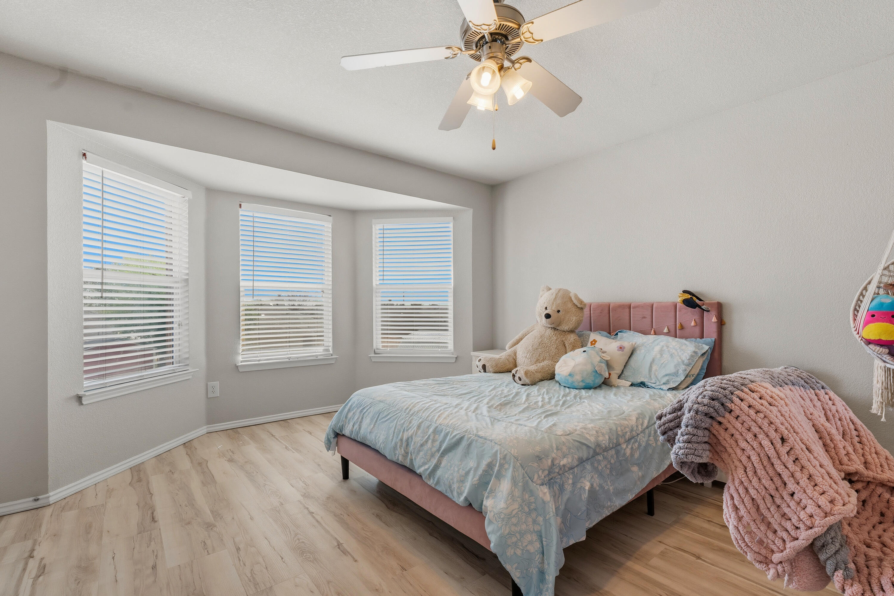 5833 102nd Street Lubbock, TX 79424 - Photo 23 of 36 a bedroom with a large bed and a chandelier