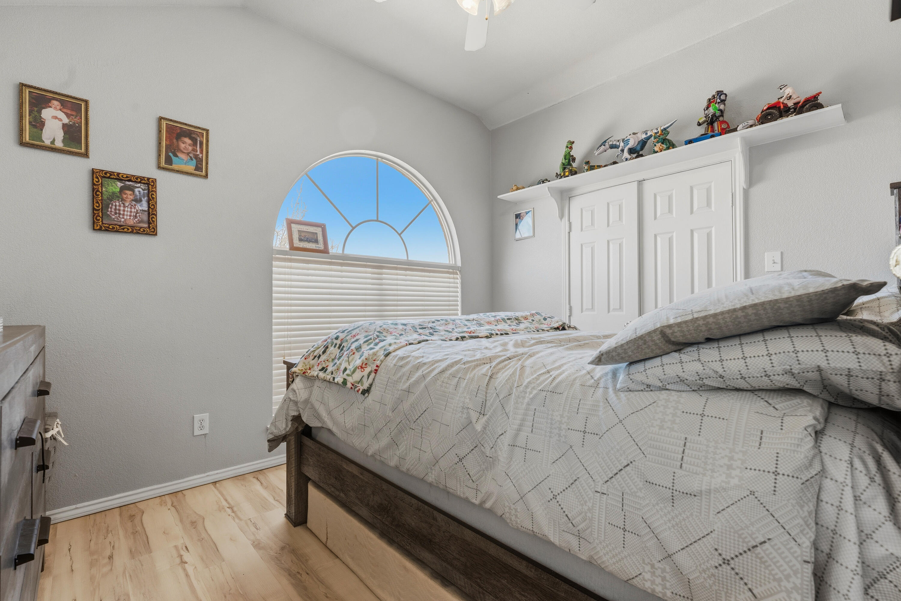 5833 102nd Street Lubbock, TX 79424 - Photo 24 of 36 a bed sitting in a bedroom next to a window