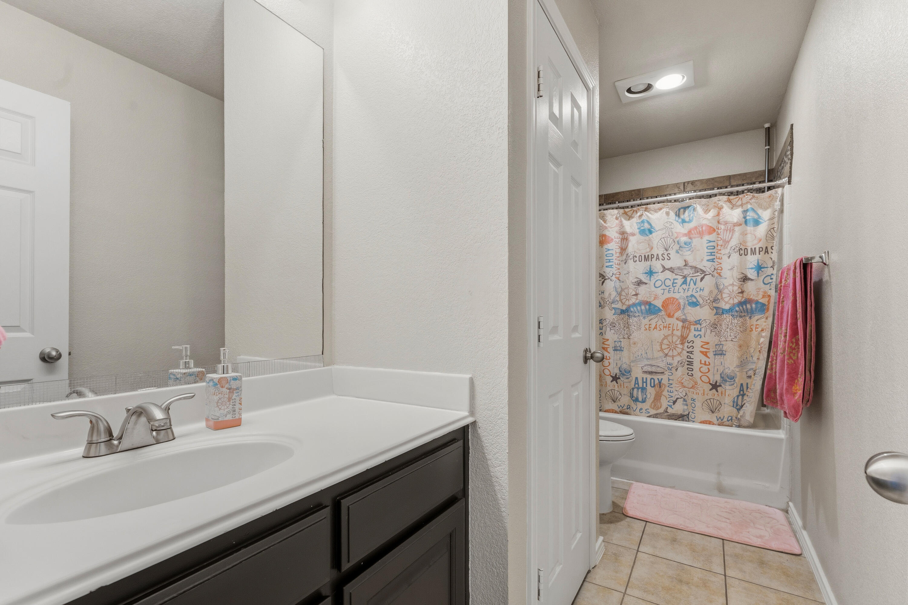 5833 102nd Street Lubbock, TX 79424 - Photo 26 of 36 a bathroom with a sink and a mirror