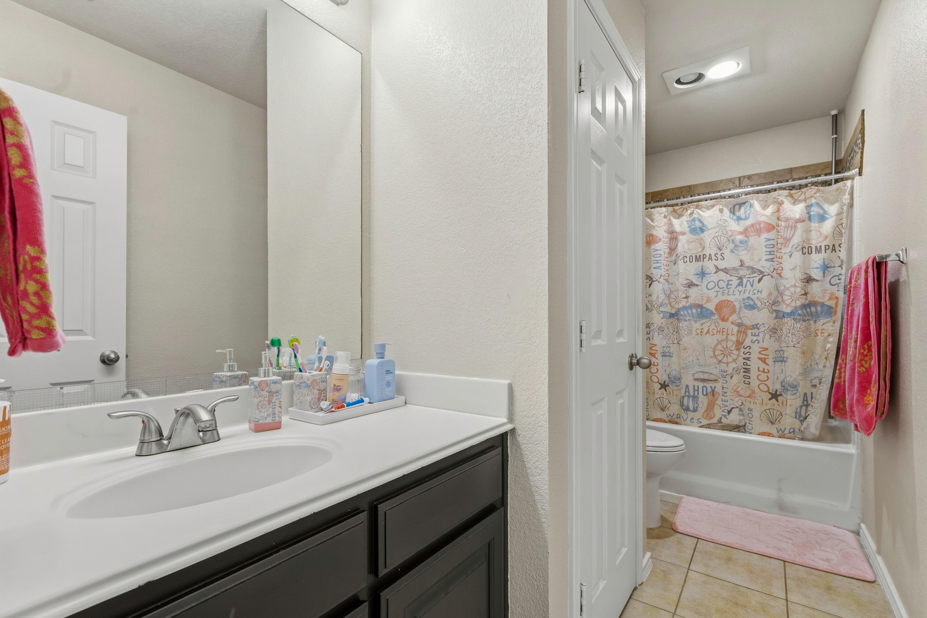 5833 102nd Street Lubbock, TX 79424 - Photo 27 of 36 a bathroom with a sink and a mirror