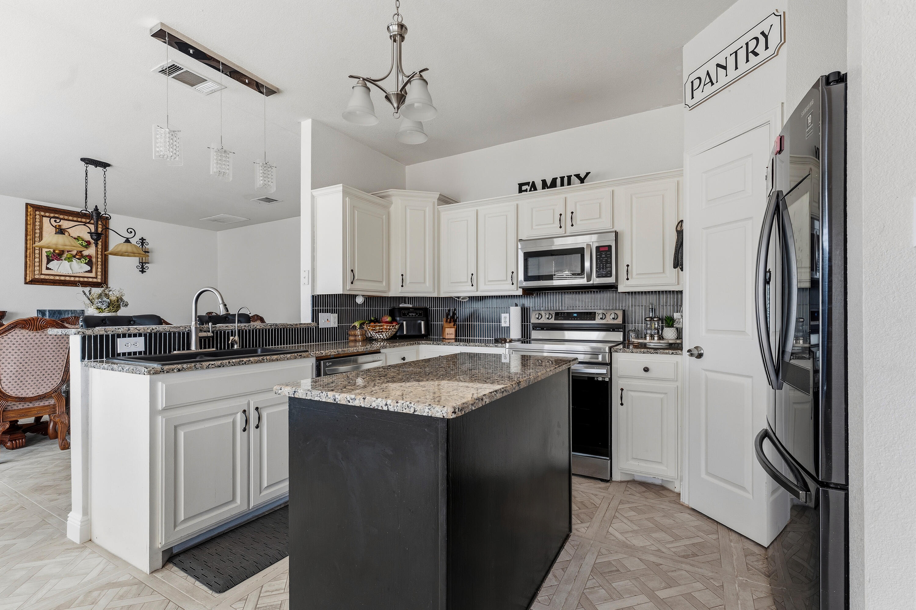 5833 102nd Street Lubbock, TX 79424 - Photo 3 of 36 a kitchen with cabinets a sink and stainless steel appliances