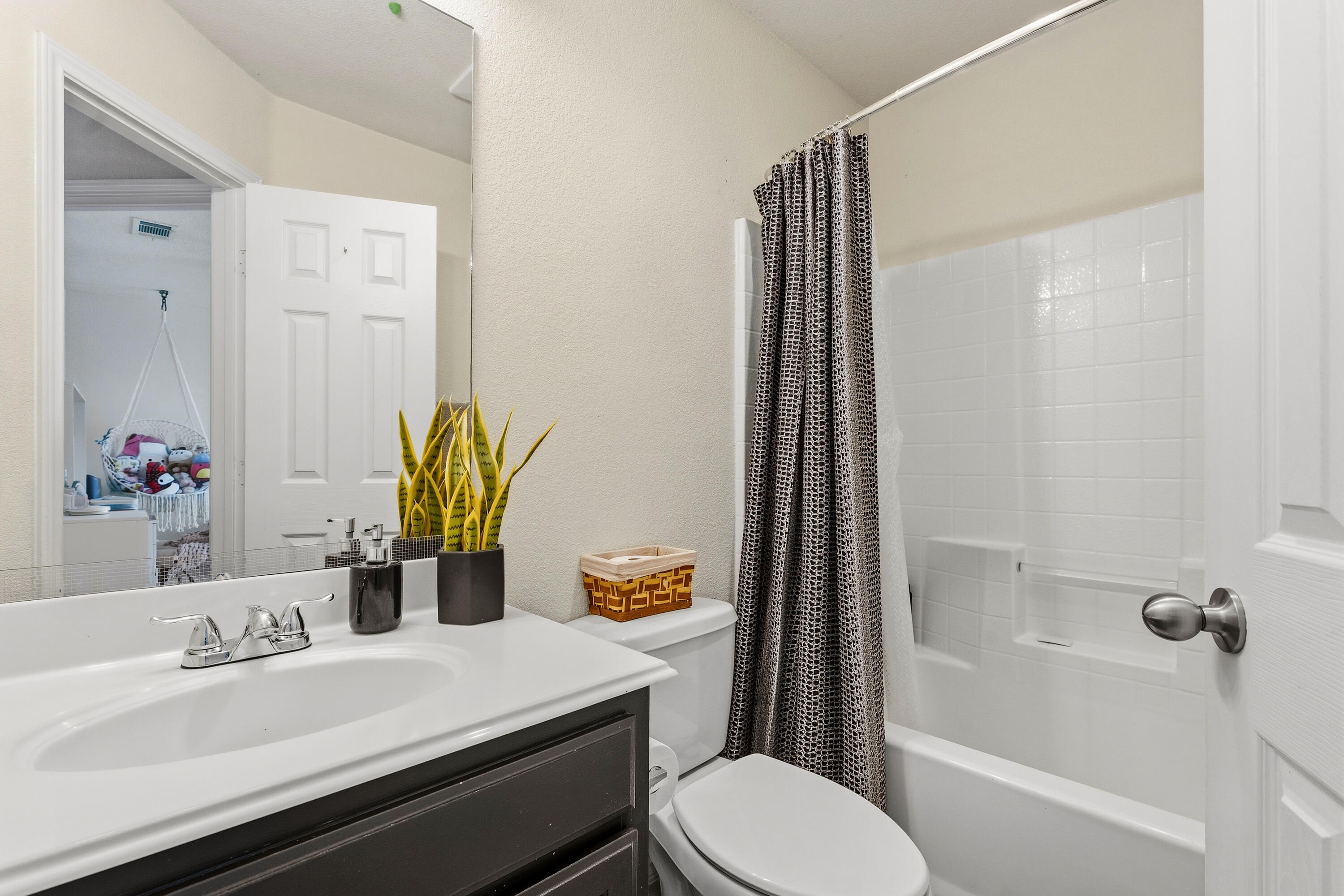 5833 102nd Street Lubbock, TX 79424 - Photo 31 of 36 a bathroom with a sink a toilet and shower