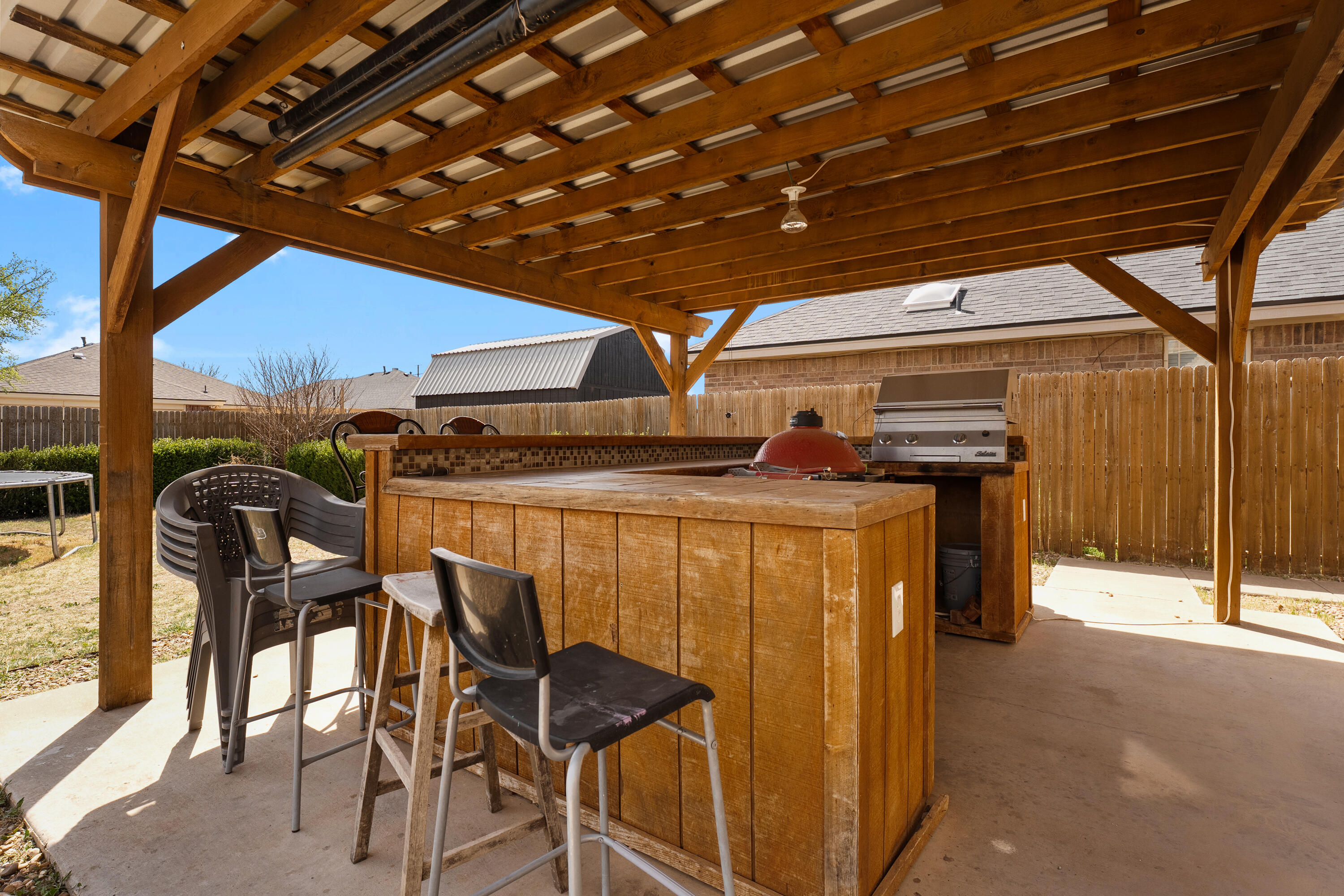 5833 102nd Street Lubbock, TX 79424 - Photo 35 of 36 a view of a patio with table and chairs with wooden floor and fence