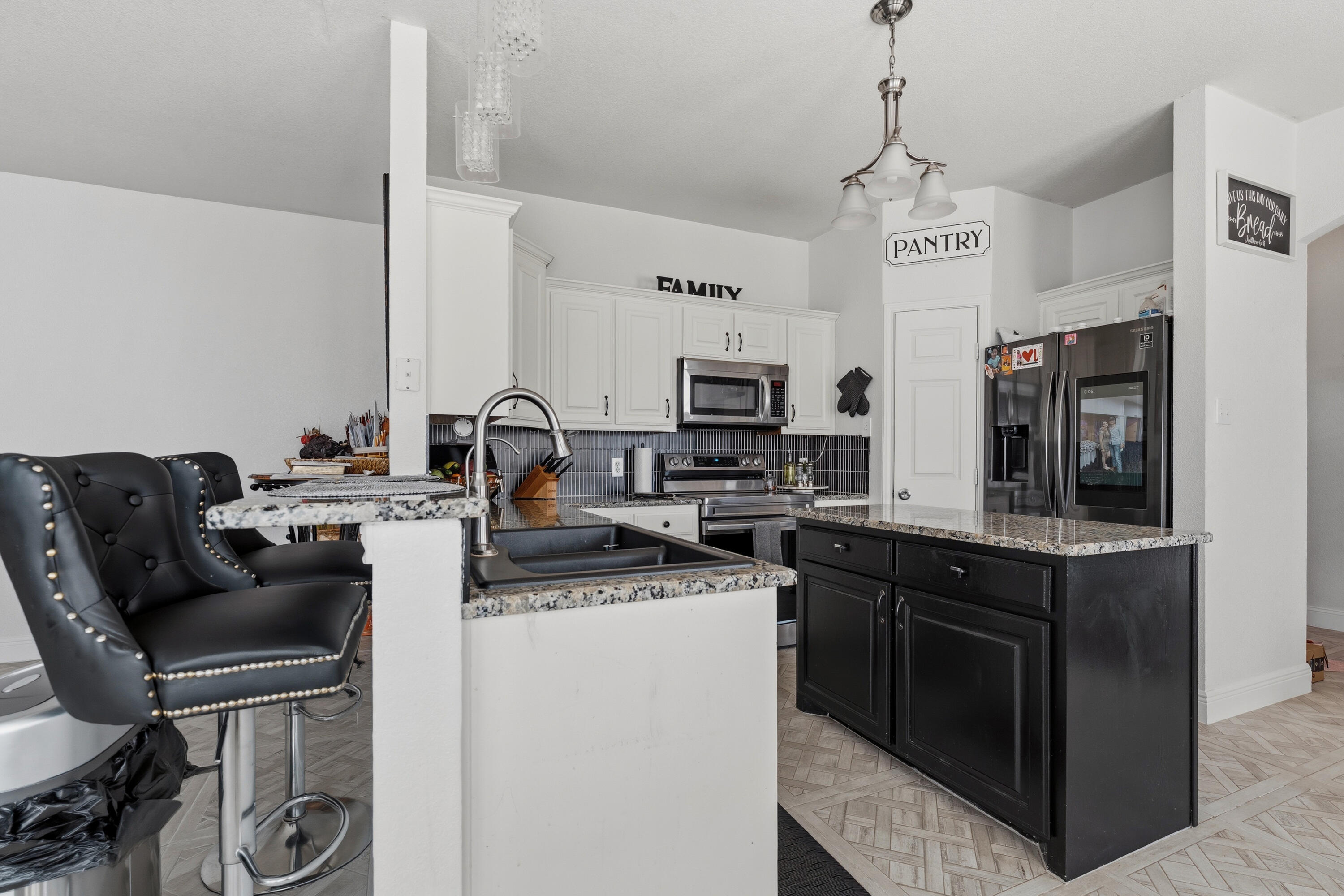 5833 102nd Street Lubbock, TX 79424 - Photo 4 of 36 a kitchen with a sink stove and microwave