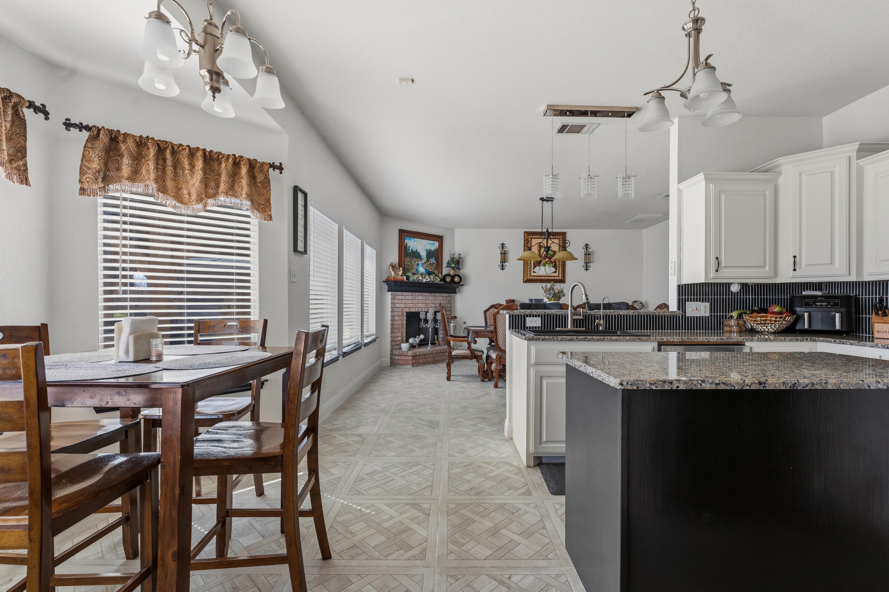 5833 102nd Street Lubbock, TX 79424 - Photo 5 of 36 a kitchen with stainless steel appliances granite countertop table chairs sink and cabinets