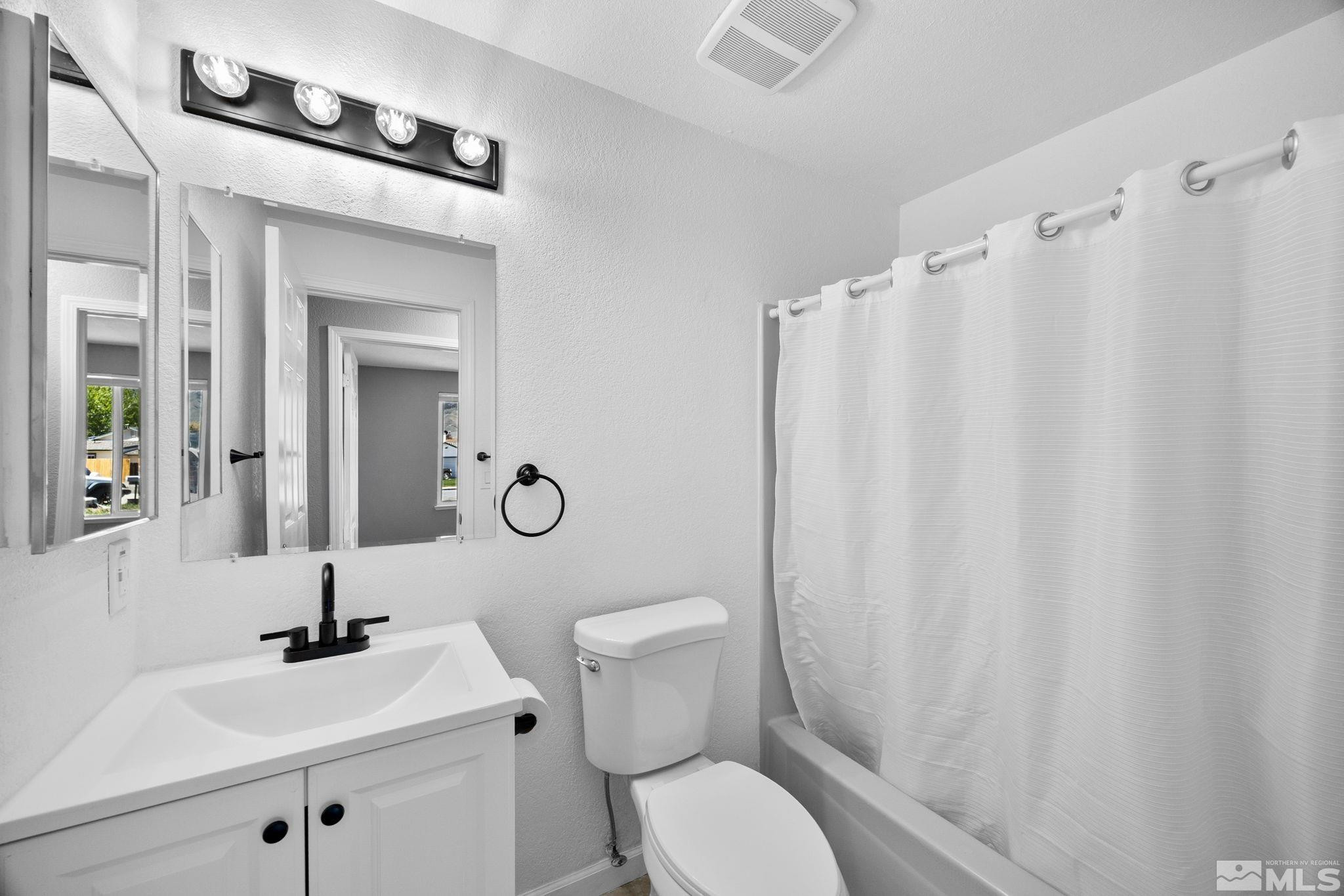 10069 Basalt Court Reno, NV 89506 - Photo 17 of 30 a bathroom with a sink a toilet and shower