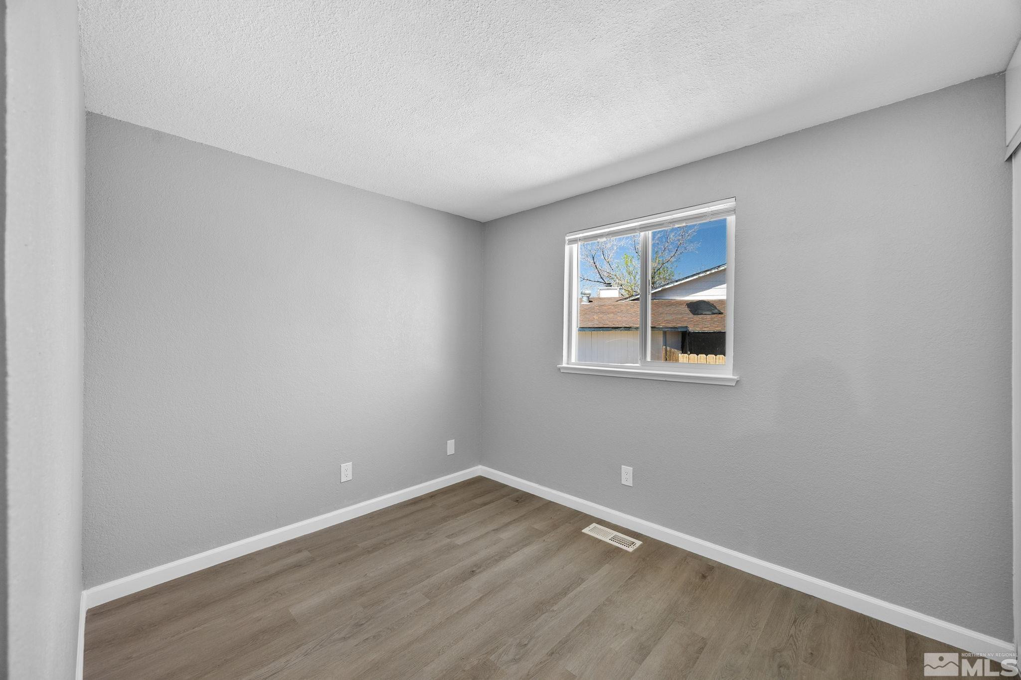 10069 Basalt Court Reno, NV 89506 - Photo 18 of 30 an empty room with a workspace and a window