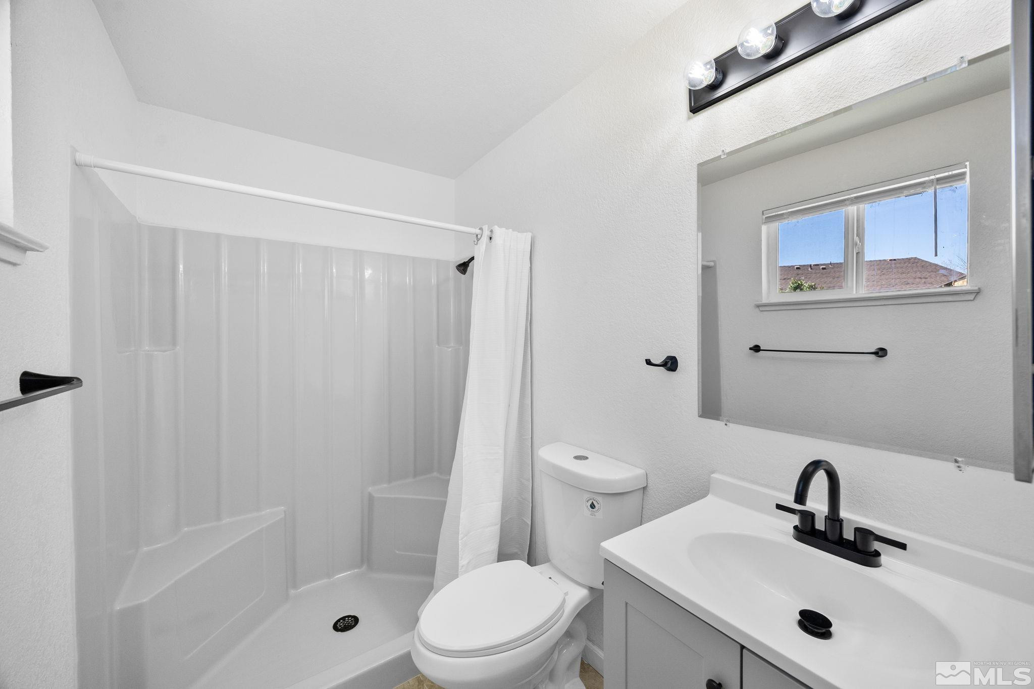10069 Basalt Court Reno, NV 89506 - Photo 23 of 30 a bathroom with a sink mirror shower and toilet