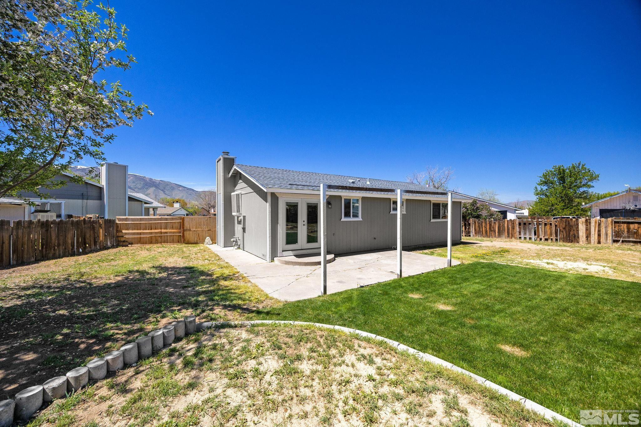 10069 Basalt Court Reno, NV 89506 - Photo 26 of 30 a view of a house with backyard and a tree