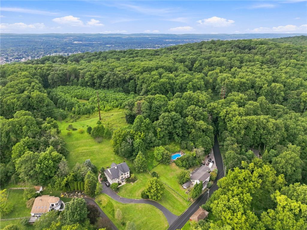 3408 Oak Hill Road Emmaus, PA 18049 - Photo 76 of 93 Aerial view reveals a private hillside setting surrounded by dense woods and valley views.